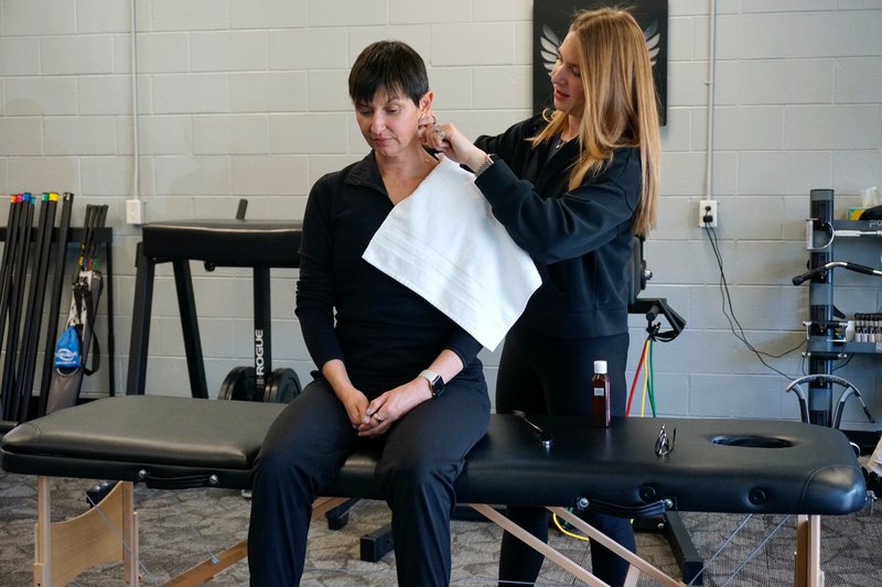 Omega performing hands-on treatment with a patient in the clinic