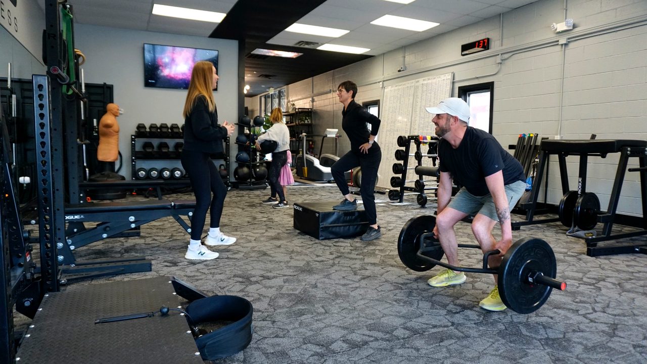 Physical therapist coaching strength work in a Niwot clinic